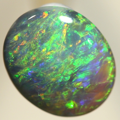 SOLID BLACK OPAL Bright orange and green over a blue background. SEE VIDEO